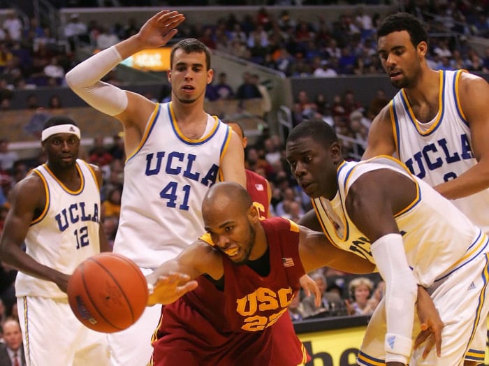 Holiday (right of the basketball with a shooting sleeve on his left arm) during his time with the Bruins)
